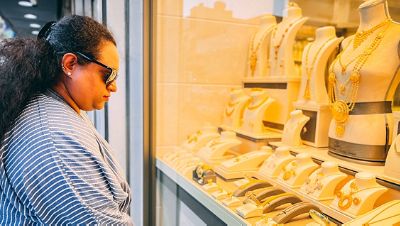 A tourist watches the jewelry stall at the Love Souk in Dammam