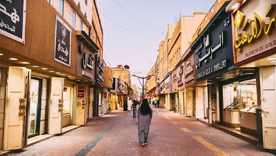 A number of visitors walk through the Love Market